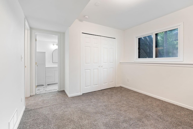 unfurnished bedroom featuring carpet flooring and a closet