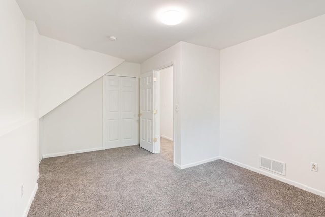 bonus room featuring light carpet and lofted ceiling