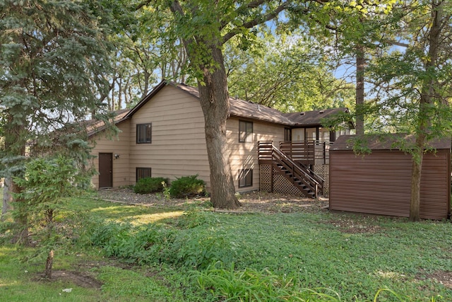 rear view of house featuring a yard and a deck