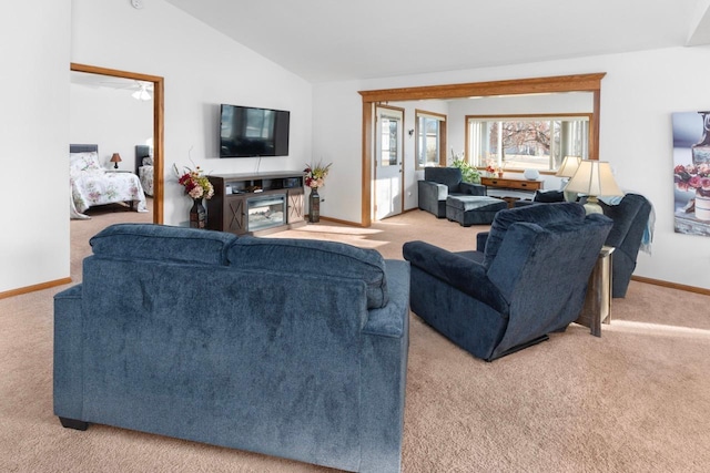 carpeted living room featuring ceiling fan and lofted ceiling