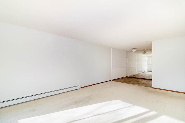 empty room featuring carpet and a baseboard radiator