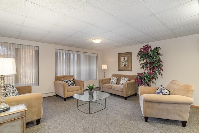 carpeted living room with a paneled ceiling and a baseboard radiator