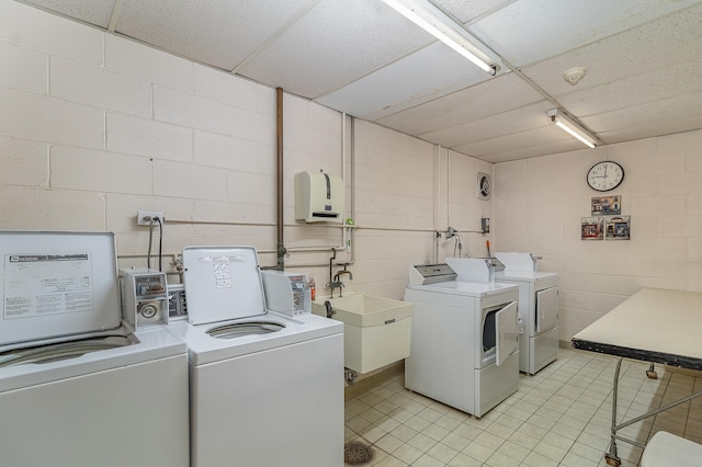 laundry room with washing machine and dryer and sink