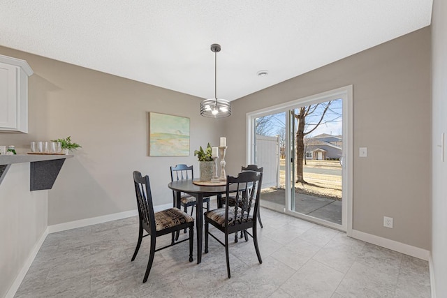 dining space featuring an inviting chandelier