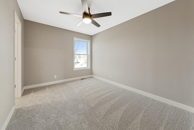 spare room with ceiling fan and carpet floors