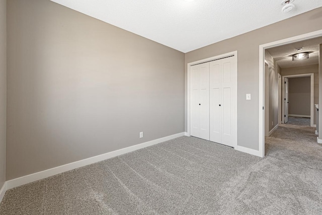 unfurnished bedroom with light carpet and a closet