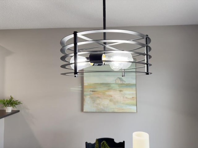 room details with a textured ceiling and an inviting chandelier