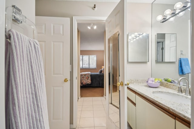 bathroom with tile patterned flooring and vanity