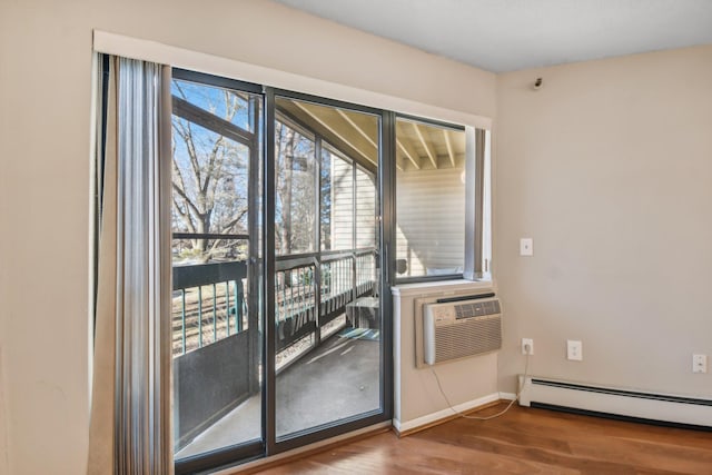 entryway featuring hardwood / wood-style floors, baseboard heating, and a wall unit AC