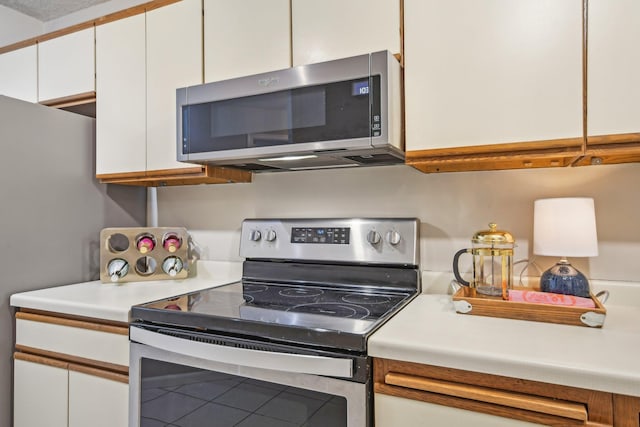 kitchen featuring white cabinetry and stainless steel appliances