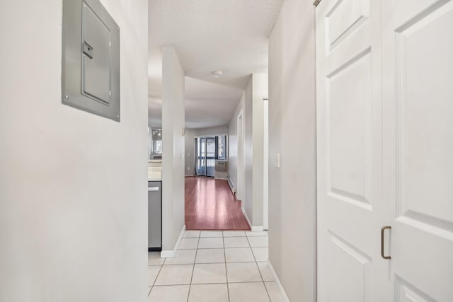 hall featuring light tile patterned floors