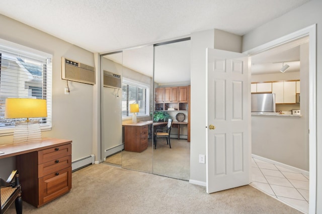 home office with light colored carpet, a wall mounted AC, and a baseboard radiator