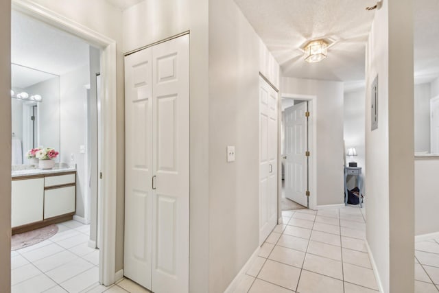 hall featuring light tile patterned floors