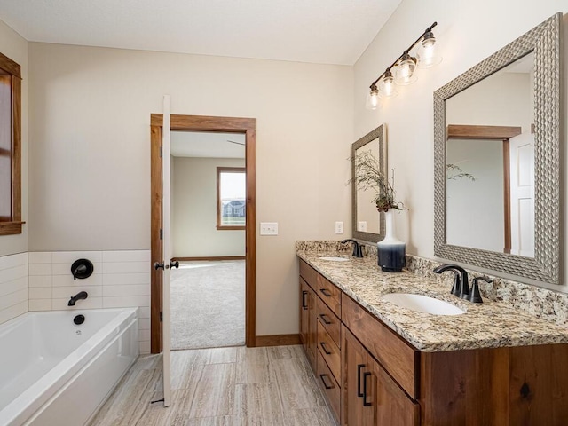 bathroom featuring vanity and a washtub