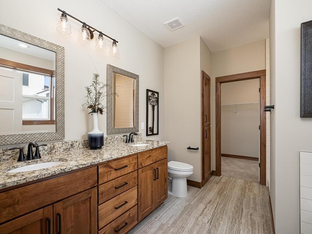 bathroom featuring hardwood / wood-style floors, vanity, and toilet