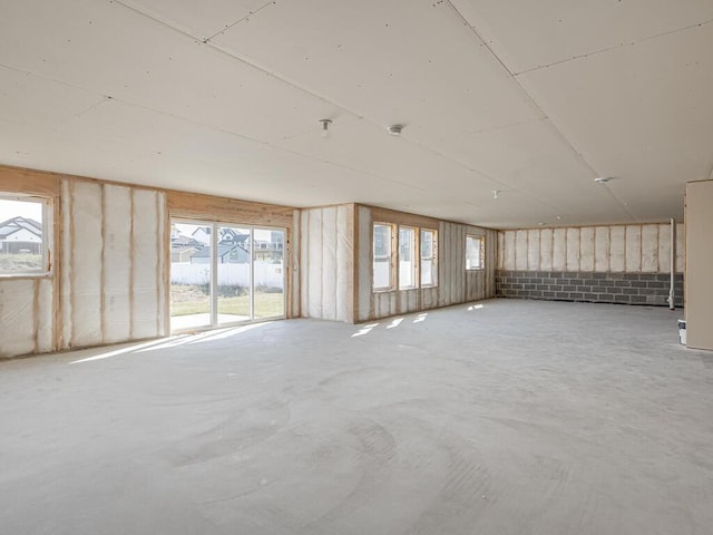 spare room with concrete floors and a healthy amount of sunlight