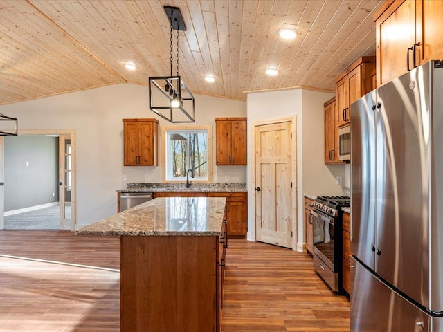 kitchen featuring pendant lighting, wood ceiling, appliances with stainless steel finishes, a center island, and light stone countertops