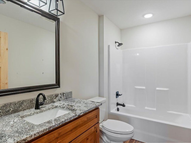 full bathroom with vanity, bathtub / shower combination, and toilet