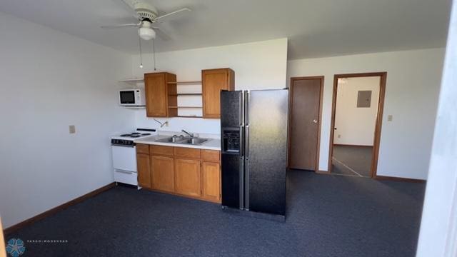 kitchen featuring white appliances, ceiling fan, sink, dark colored carpet, and electric panel