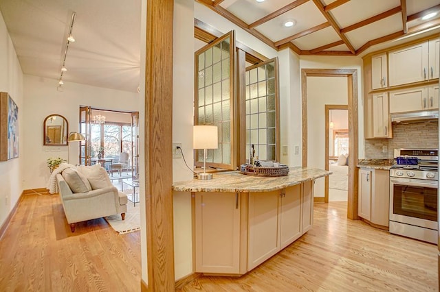 kitchen featuring stainless steel range, coffered ceiling, light hardwood / wood-style flooring, backsplash, and track lighting