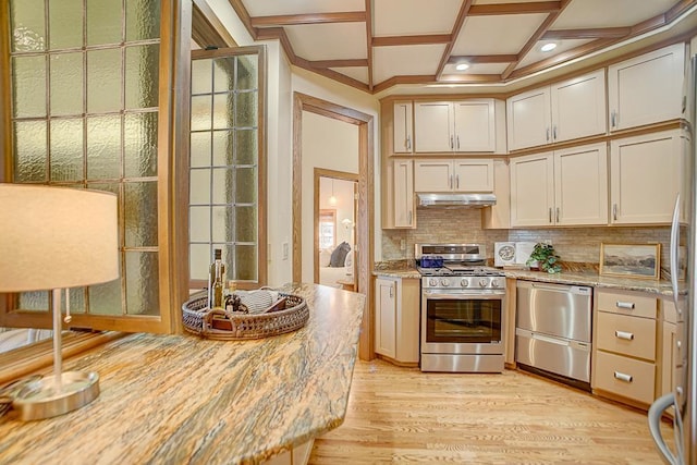 kitchen featuring light wood-type flooring, tasteful backsplash, light stone counters, coffered ceiling, and stainless steel appliances