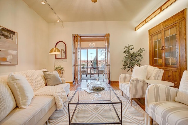 living room featuring light hardwood / wood-style floors and a notable chandelier