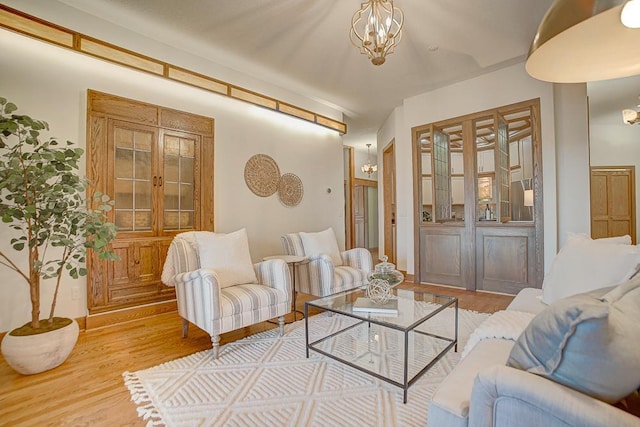 living room featuring a chandelier and light hardwood / wood-style floors