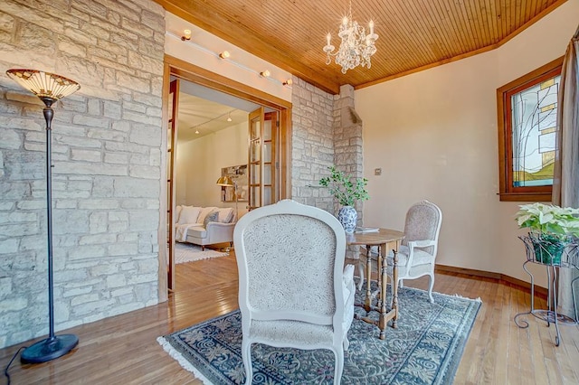 dining space with an inviting chandelier, wooden ceiling, and hardwood / wood-style flooring