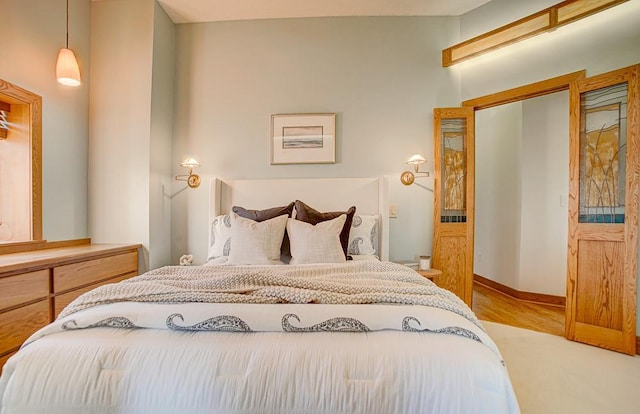 bedroom with light wood-type flooring and a closet