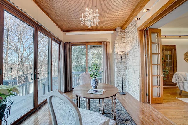 sunroom / solarium with french doors, wooden ceiling, and a notable chandelier