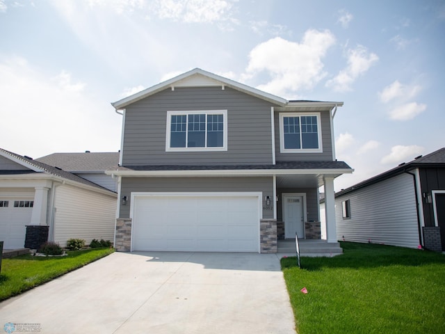 view of front facade featuring a garage and a front lawn