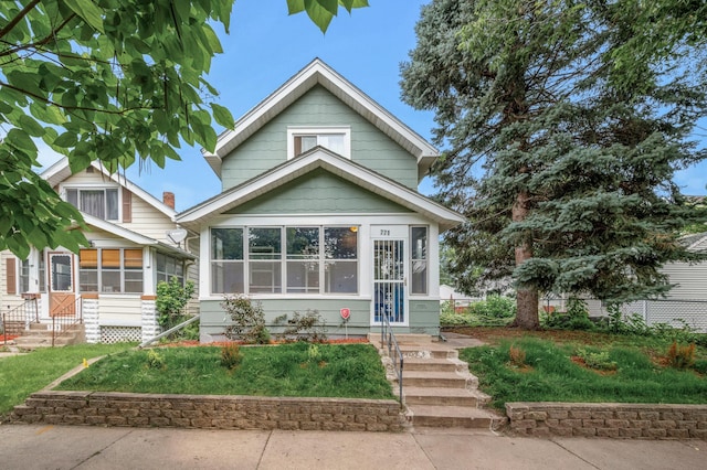 bungalow-style home with a sunroom