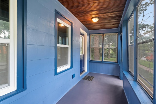 unfurnished sunroom with wooden ceiling