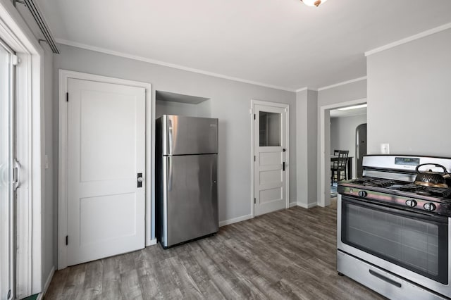 kitchen with ornamental molding, stainless steel appliances, and wood-type flooring