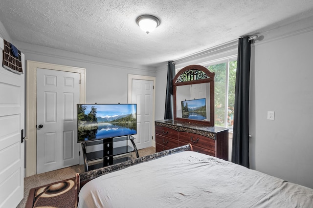 bedroom with carpet floors, a textured ceiling, and ornamental molding