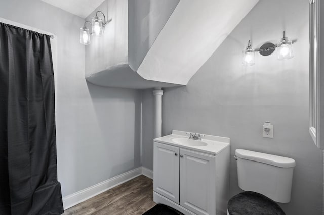 bathroom featuring hardwood / wood-style flooring, vanity, and toilet