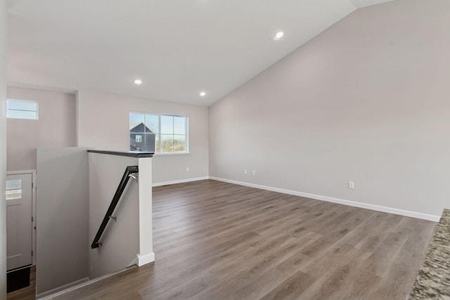 unfurnished room with wood-type flooring and lofted ceiling