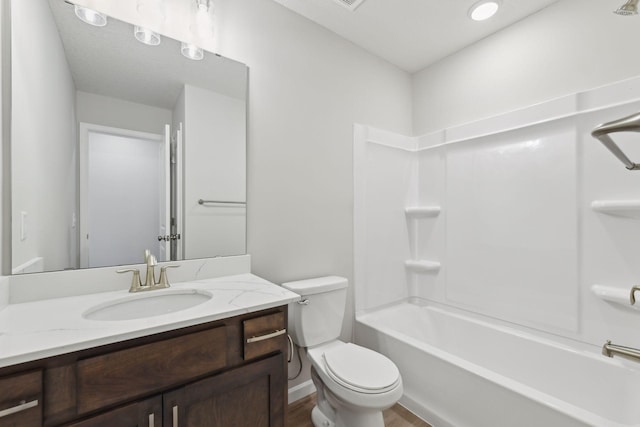 full bathroom with washtub / shower combination, vanity, wood-type flooring, and toilet