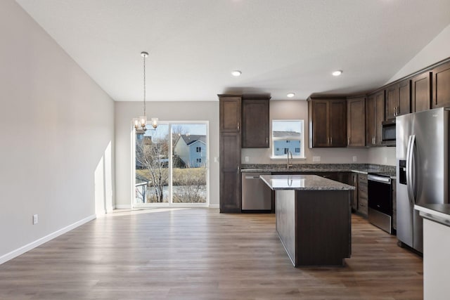 kitchen featuring a center island, hanging light fixtures, plenty of natural light, a chandelier, and appliances with stainless steel finishes