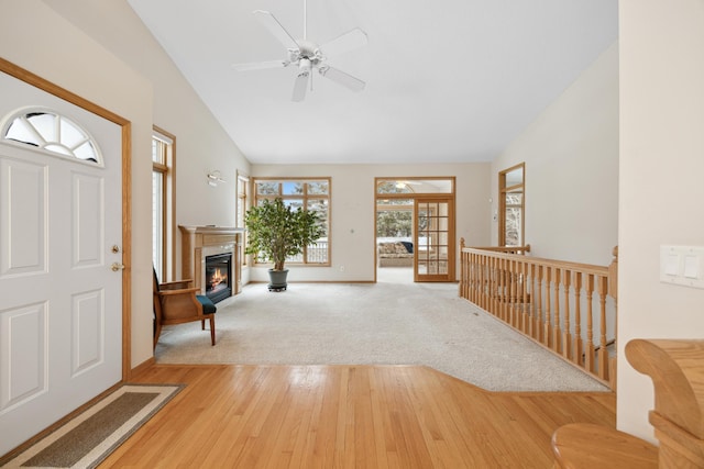 foyer featuring ceiling fan, french doors, lofted ceiling, and wood-type flooring