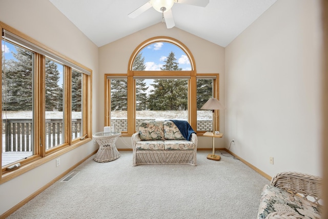 sunroom with ceiling fan and vaulted ceiling