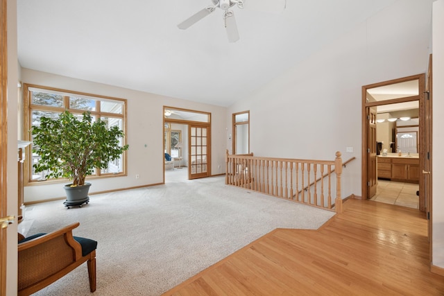 sitting room featuring vaulted ceiling, light wood-type flooring, ceiling fan, and french doors