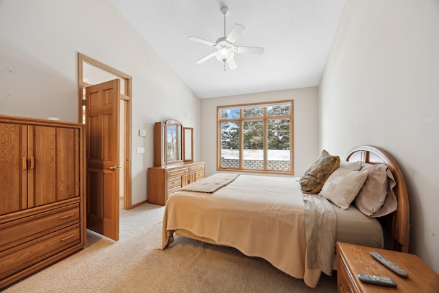 carpeted bedroom featuring lofted ceiling, a textured ceiling, and ceiling fan