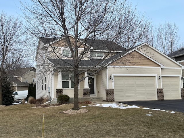 view of front of house featuring a front yard and a garage