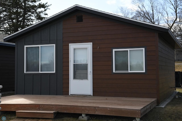 rear view of house featuring a wooden deck