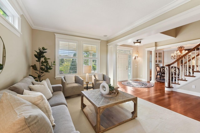 living room with a healthy amount of sunlight, crown molding, and hardwood / wood-style floors