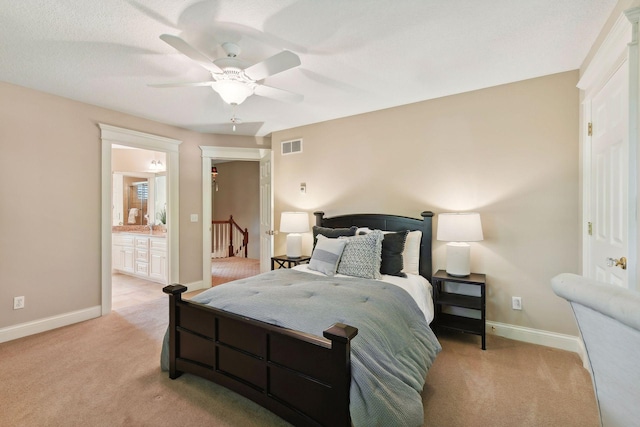 carpeted bedroom featuring ceiling fan and connected bathroom