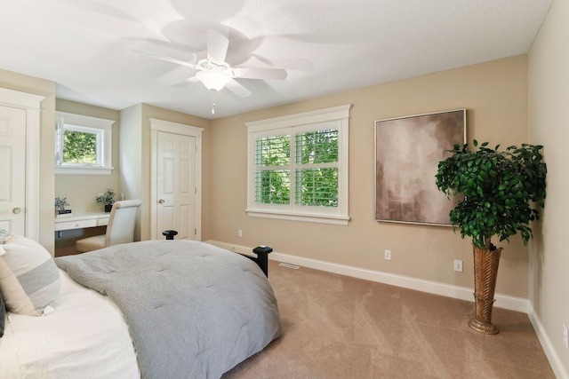 bedroom featuring ceiling fan and light colored carpet