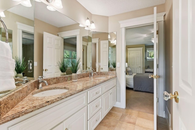 bathroom featuring vanity, plenty of natural light, and a textured ceiling