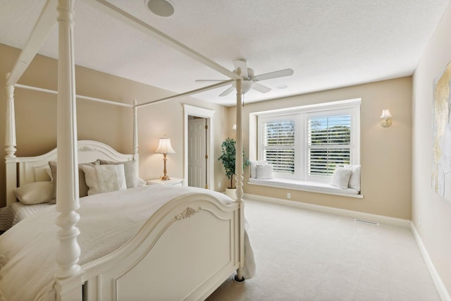 bedroom with ceiling fan and light carpet